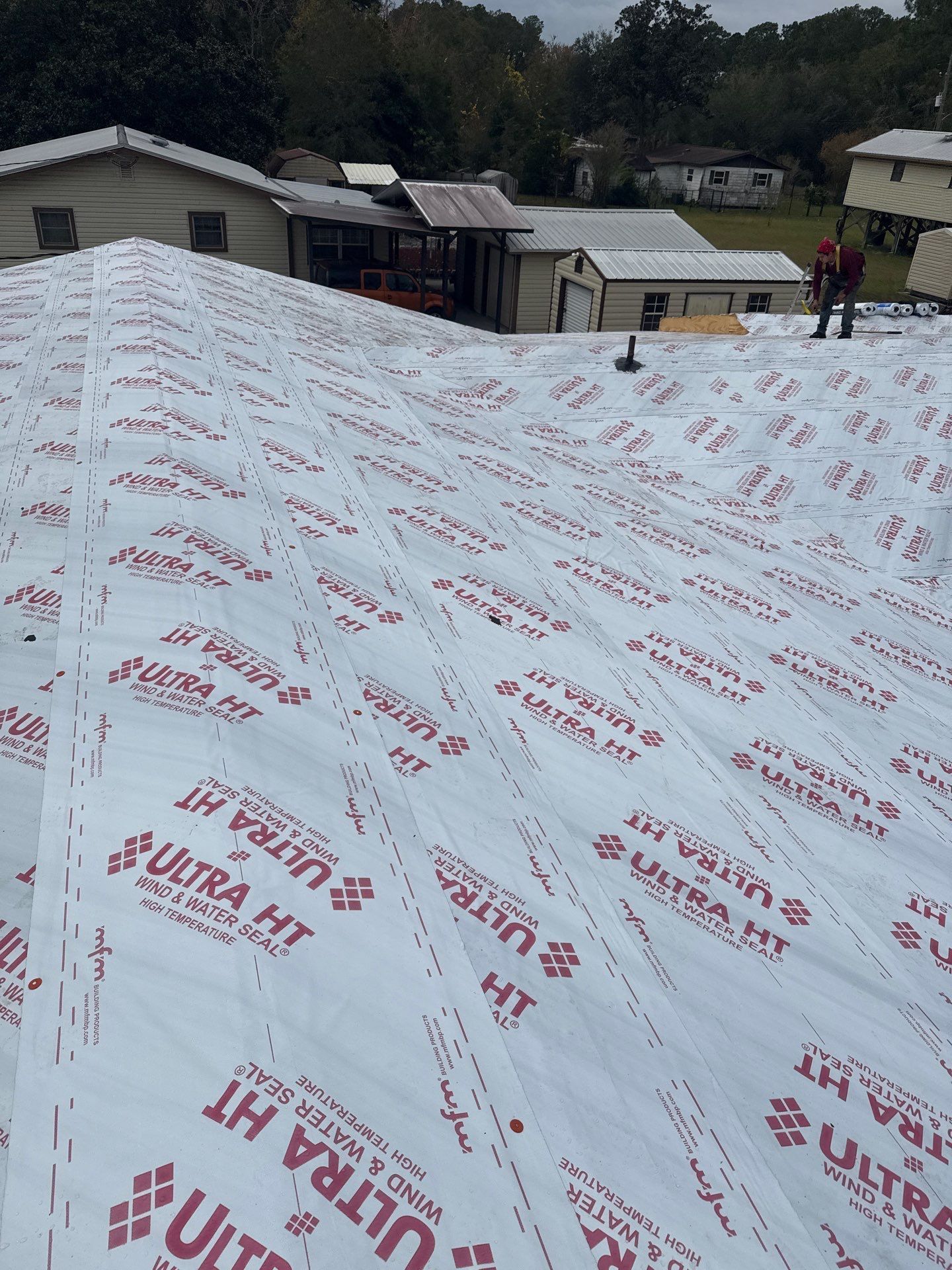 Roof partially covered with white underlayment, 