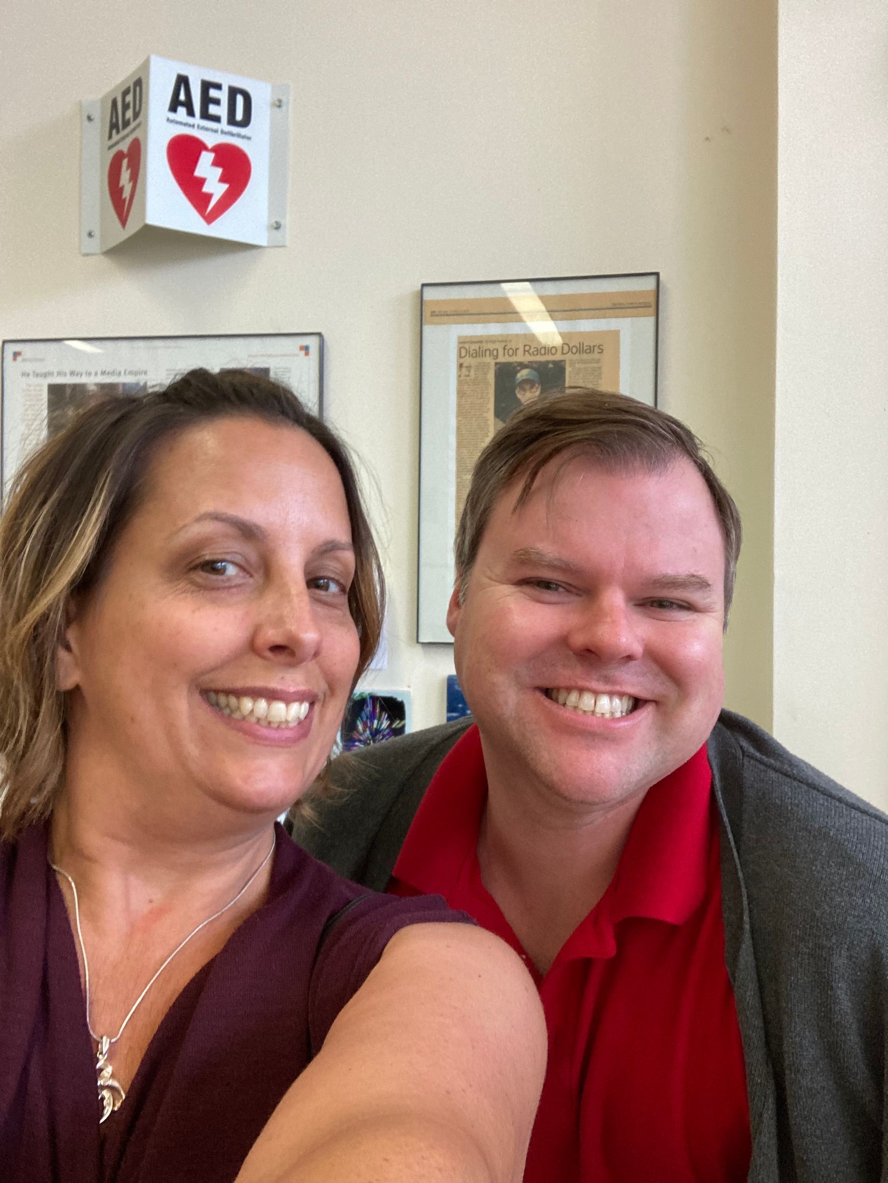 A man and a woman are smiling.