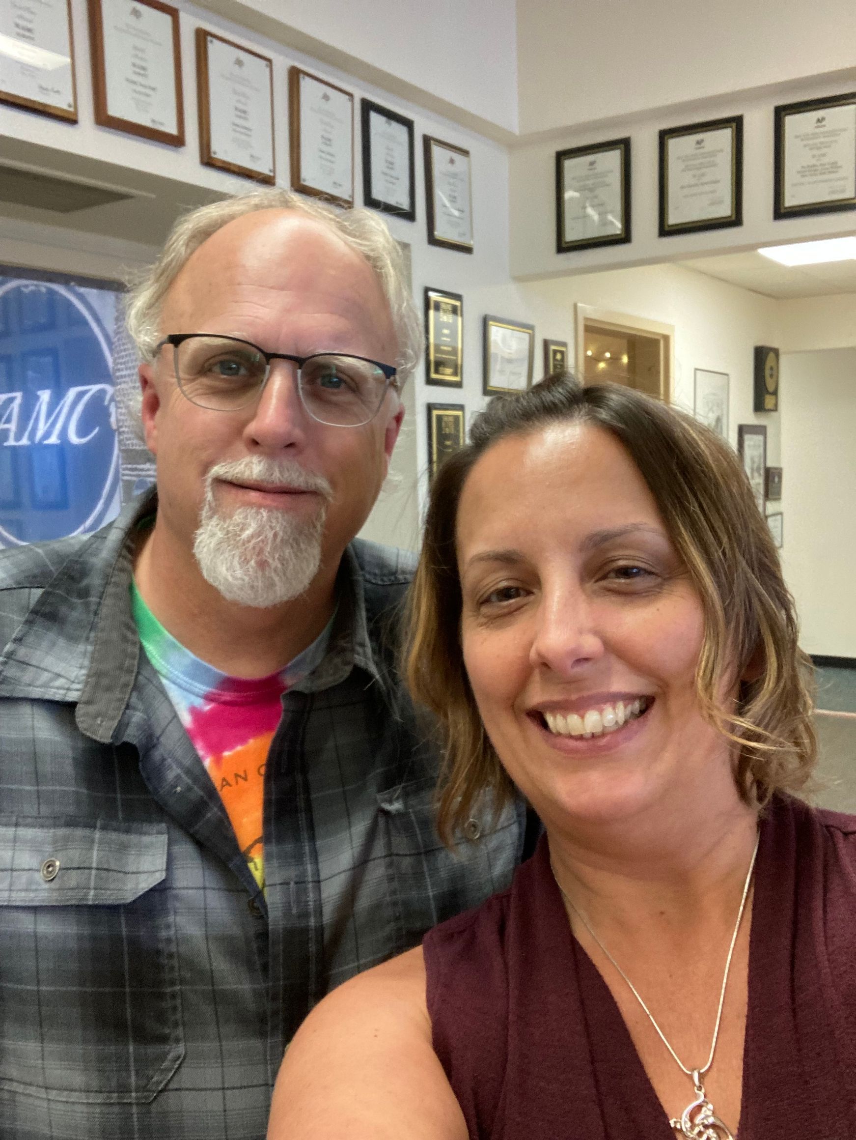 A man and a woman are posing for a picture.