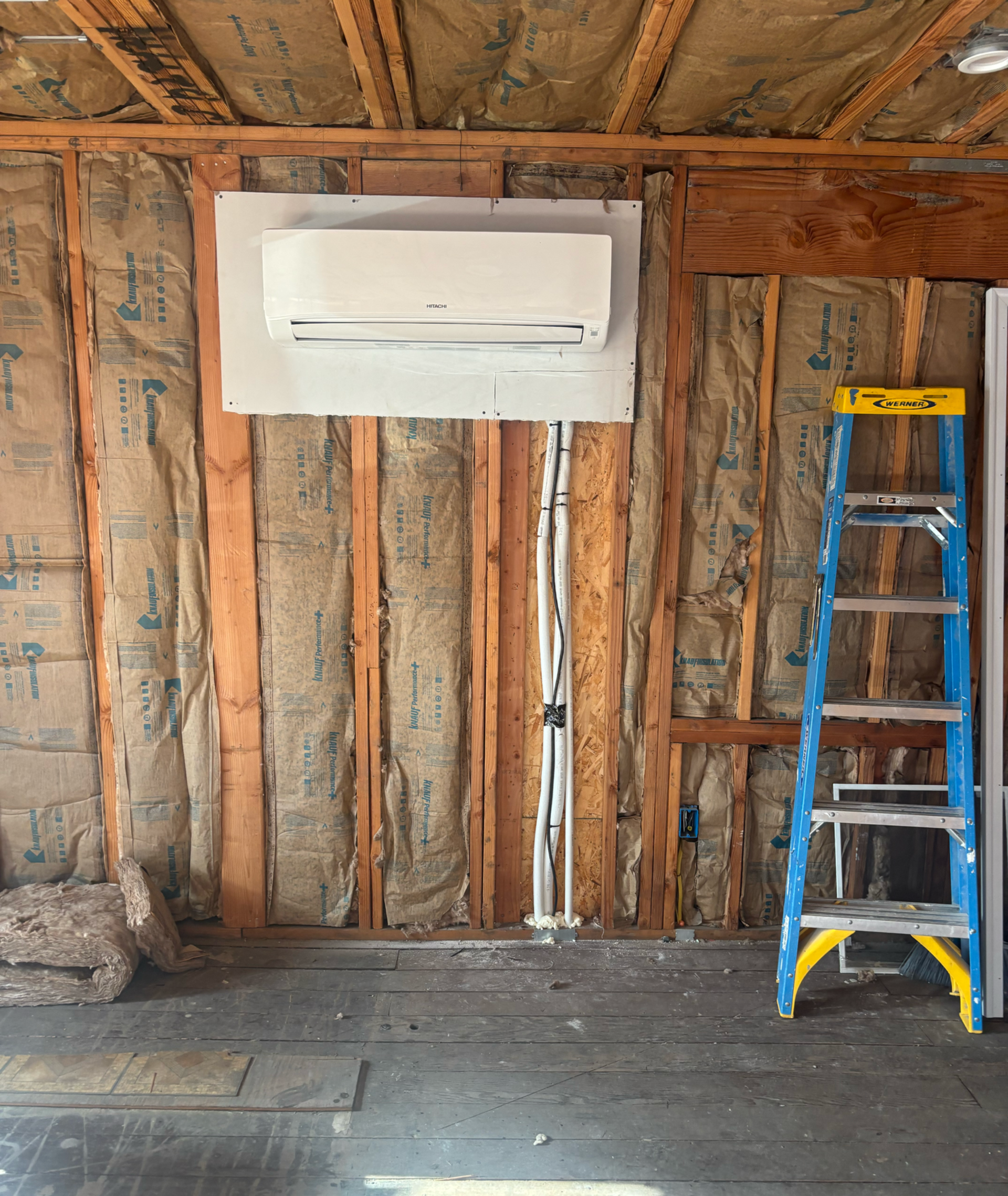Air conditioning units with toolbox and gloves in backyard.