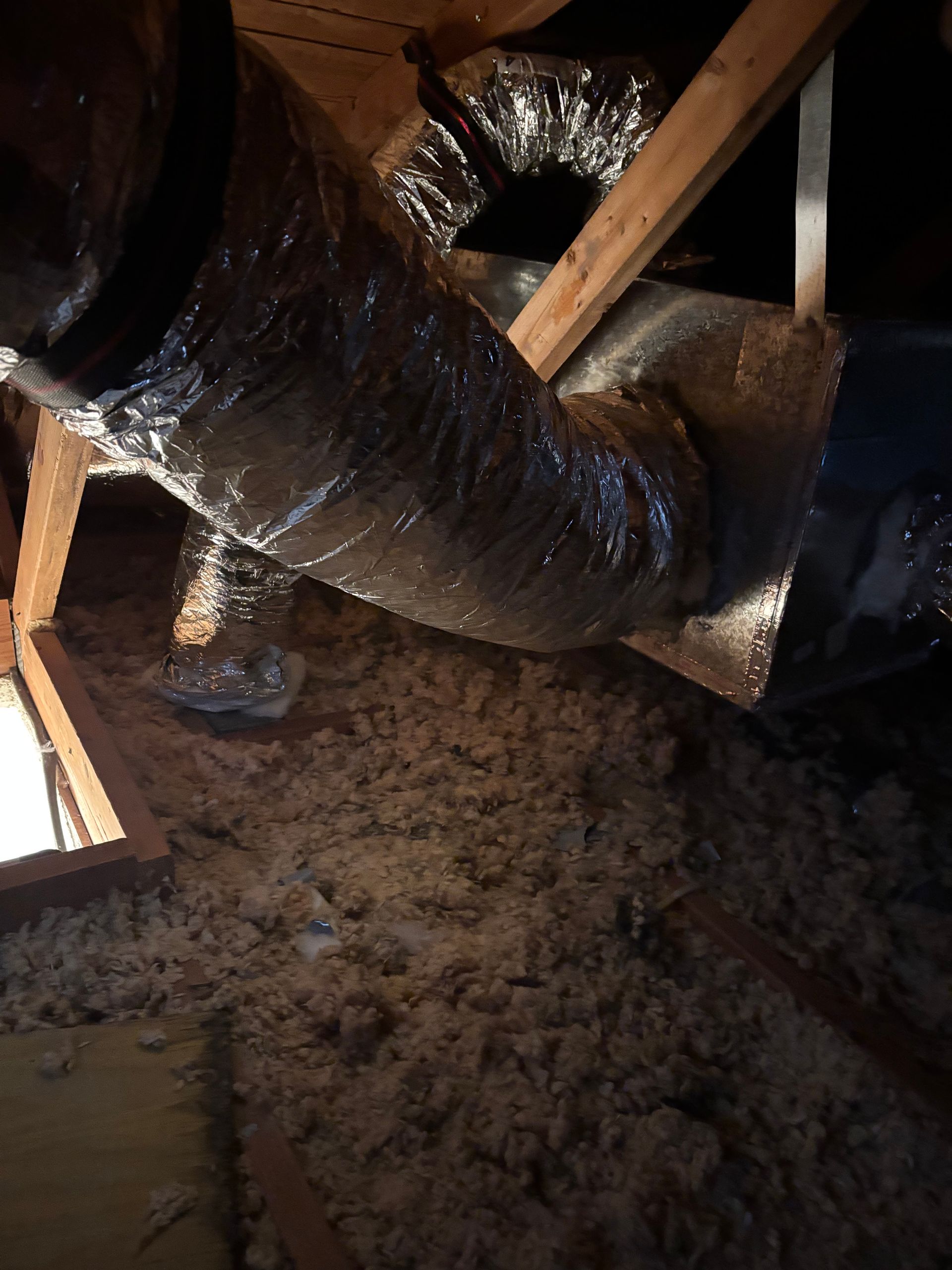 Air conditioning units with toolbox and gloves in backyard.