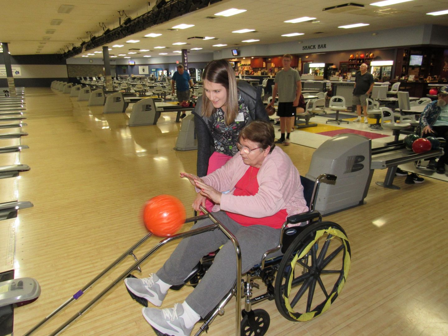 Elder pushing a bowling ball during an outing at Lenawee Medical Care Facility in Adrian, MI