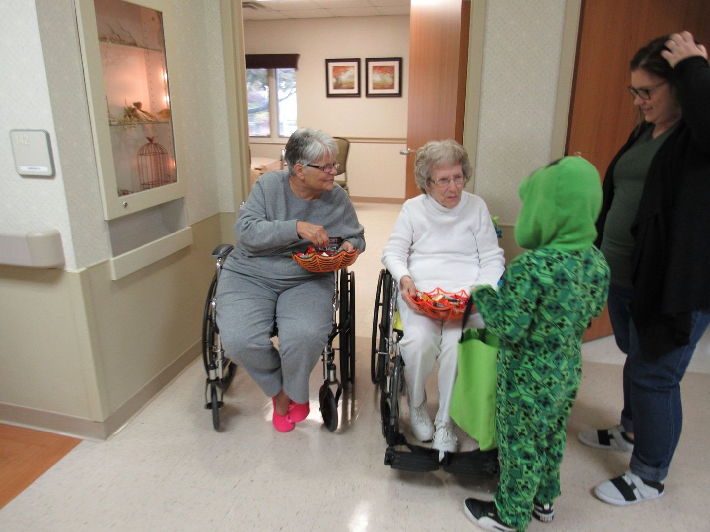 Elders handing out candy at Halloween at Lenawee Medical Care Facility in Adrian, MI
