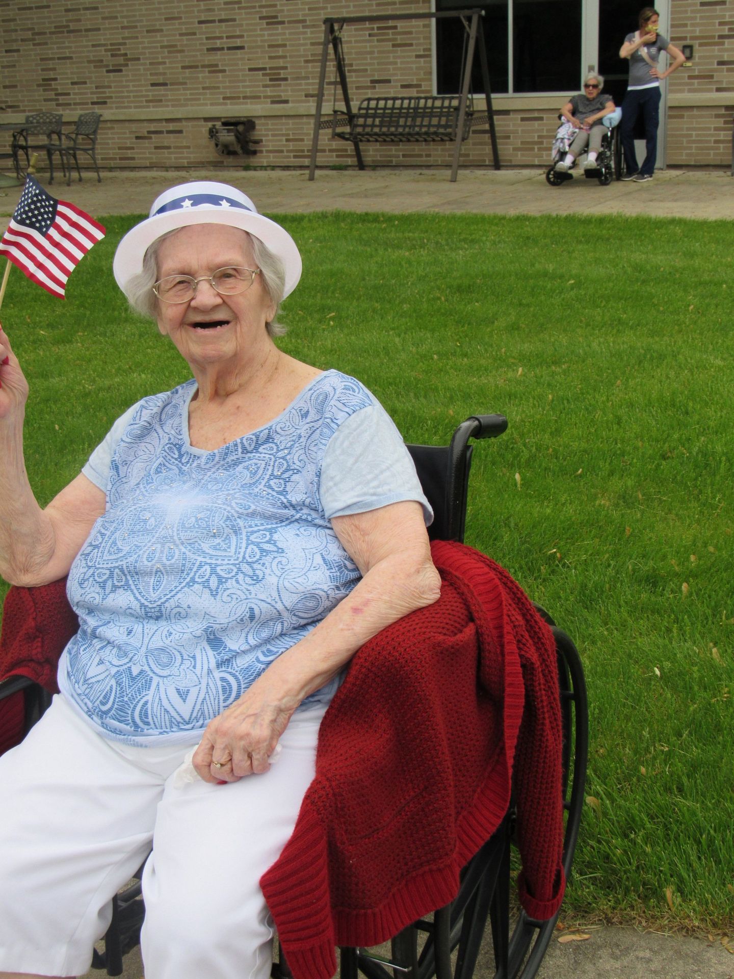 Elder holding American flag outside at Lenawee Medical Care Facility in Adrian, MI