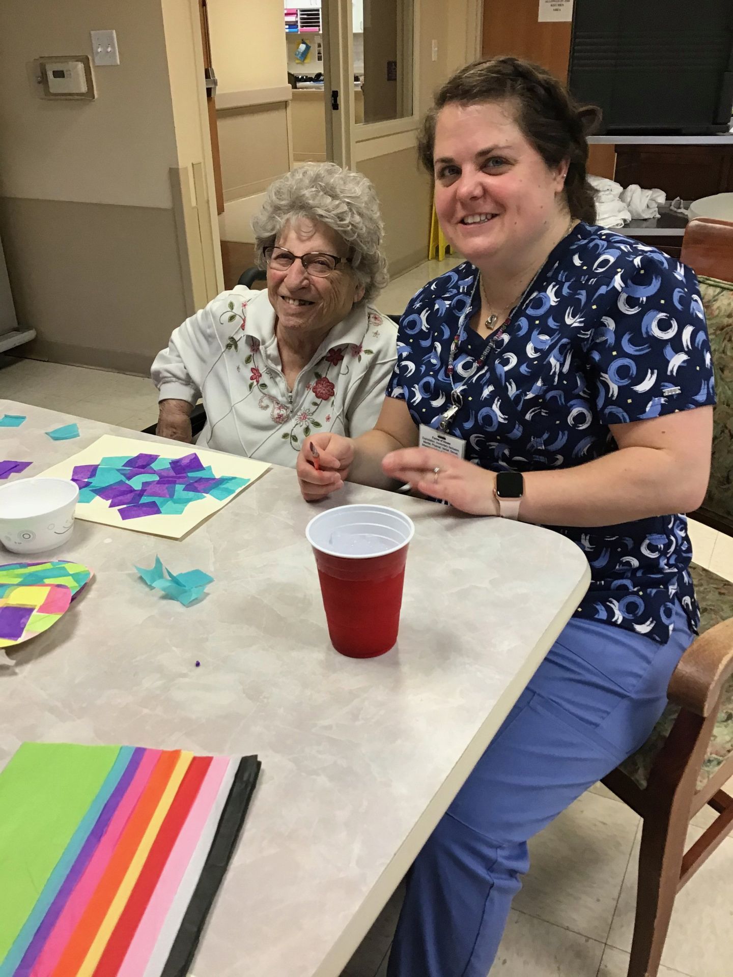 Elder and staff member doing crafts at Lenawee Medical Care Facility in Adrian, MI