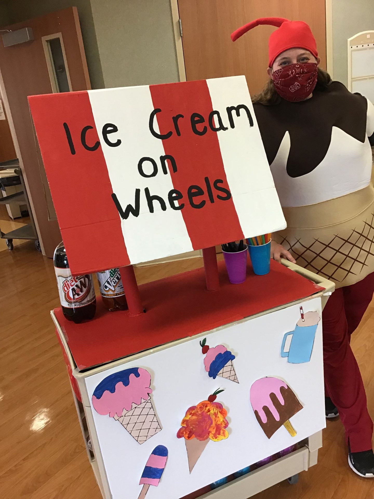 Staff member dressed up as ice cream cone handing out ice cream to Elders at Lenawee Medical Care Facility in Adrian, MI