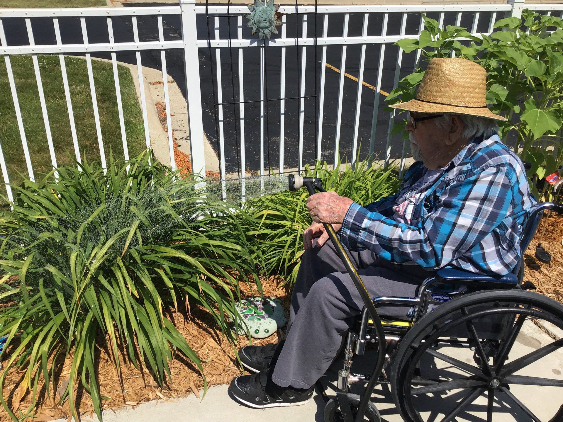 Elder Outside Watering Flowers in the Garden at Lenawee Medical Care Facility in Adrian, MI
