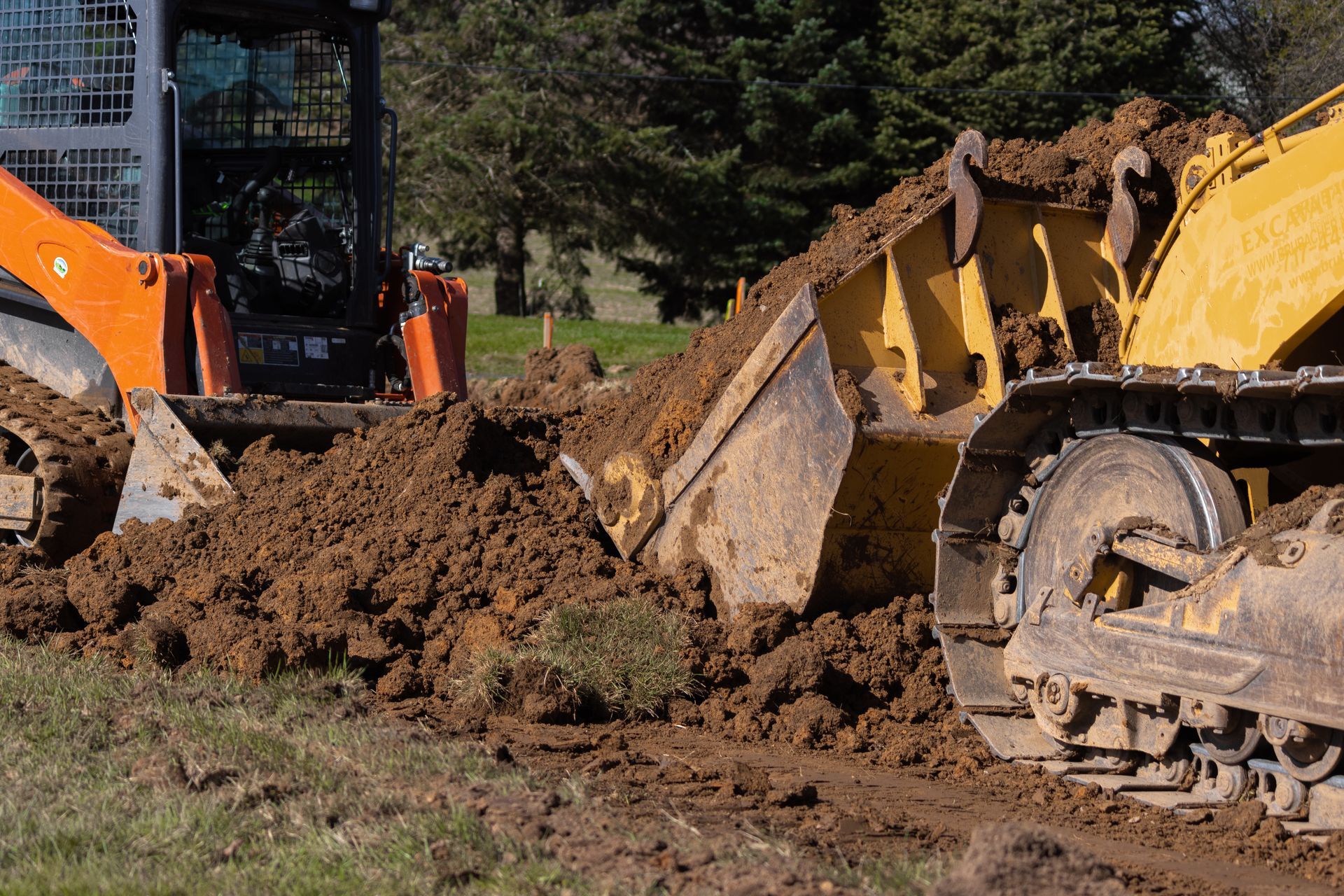 A bulldozer is moving dirt in a field.