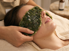 Person receiving a green jade facial massage at a spa