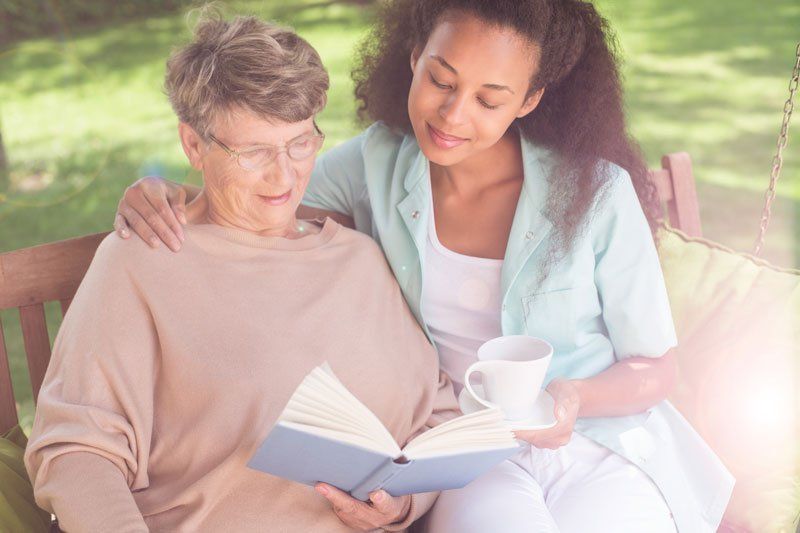 Reading with Elder Woman - Caregivers in Newport Beach, CA