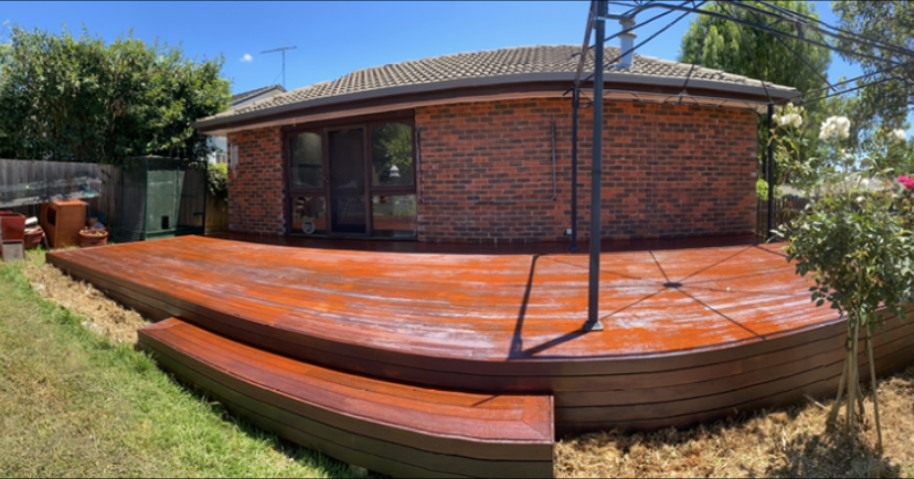 A wooden wall is being built in front of a house.