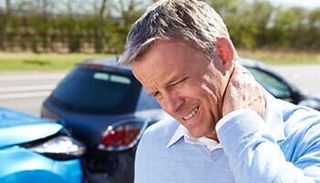 Man with neck pain after accident — Chiropractic care in Spokane, WA
