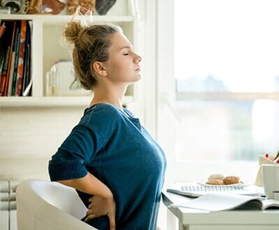Woman with backache — Chiropractic care in Spokane, WA
