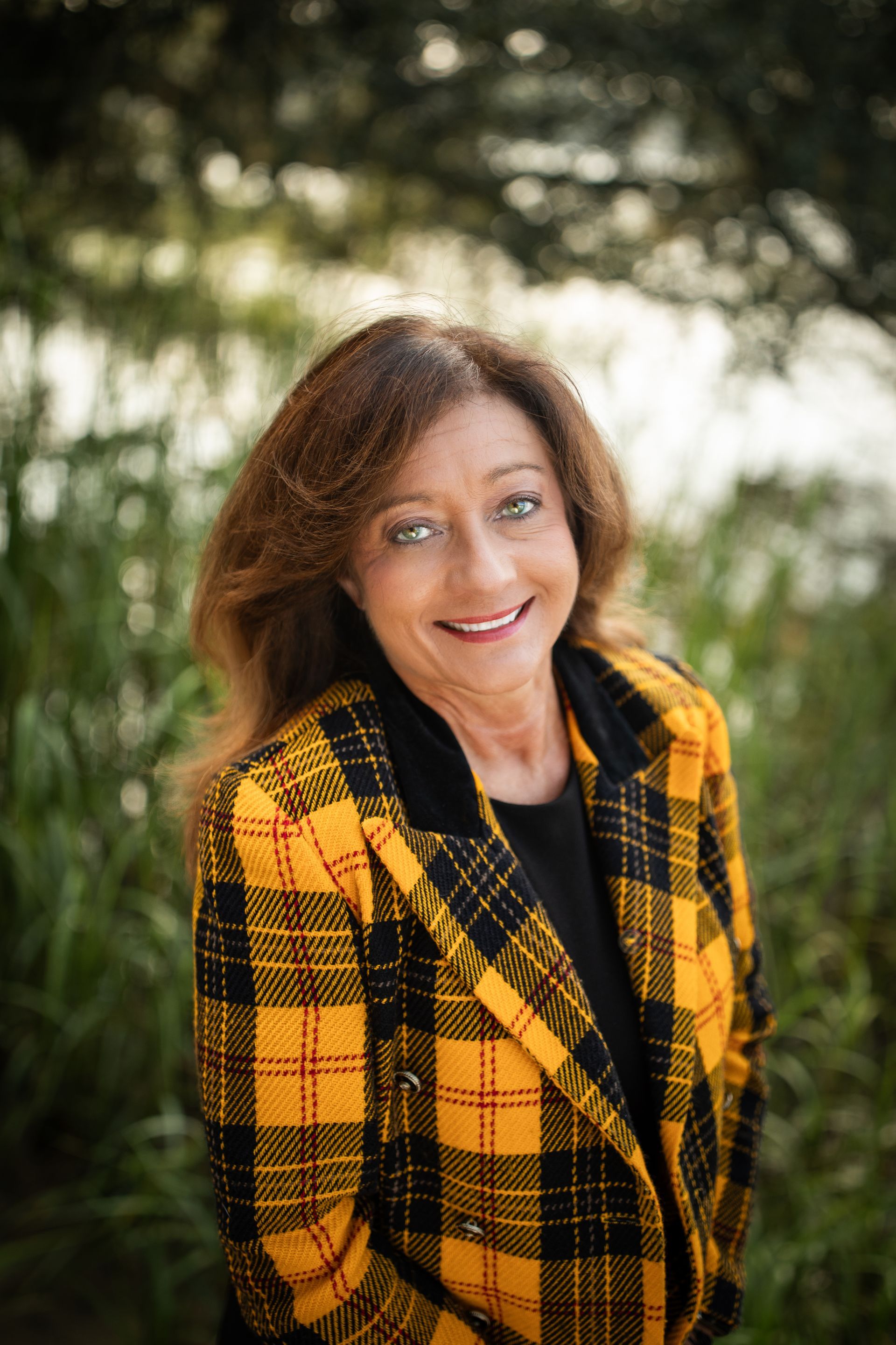 A woman without a face is wearing a suit and white shirt