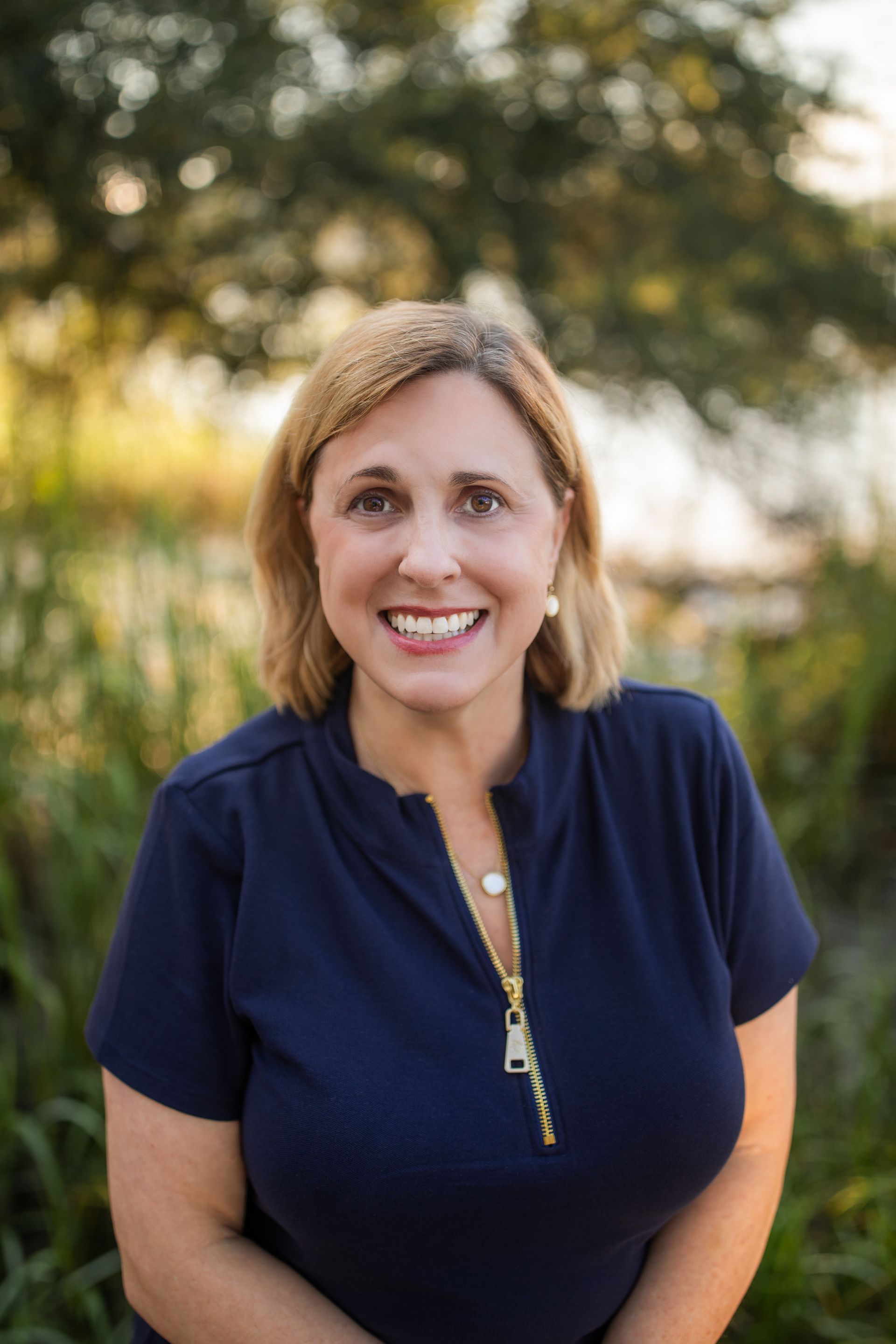 A woman without a face is wearing a suit and white shirt