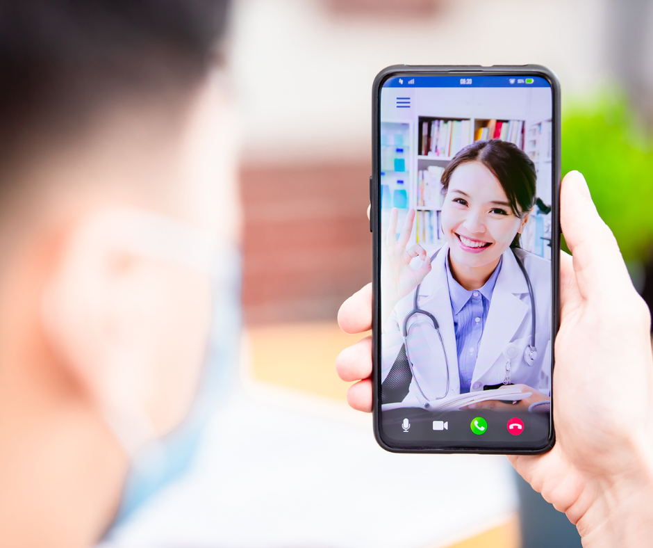 A person is holding a cell phone with a picture of a doctor on it.