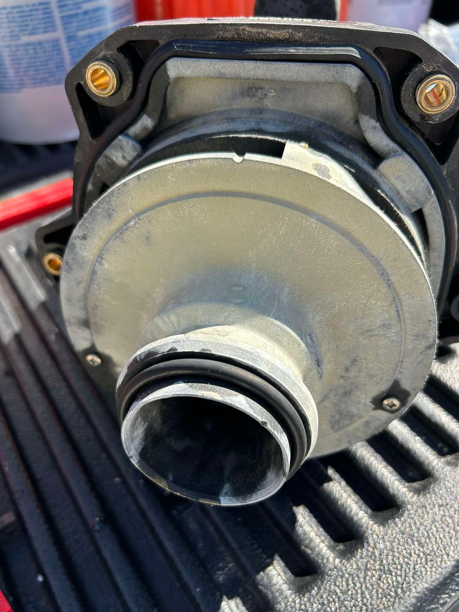 Close-up of a pump, possibly for a spa or pool, covered in a white residue.