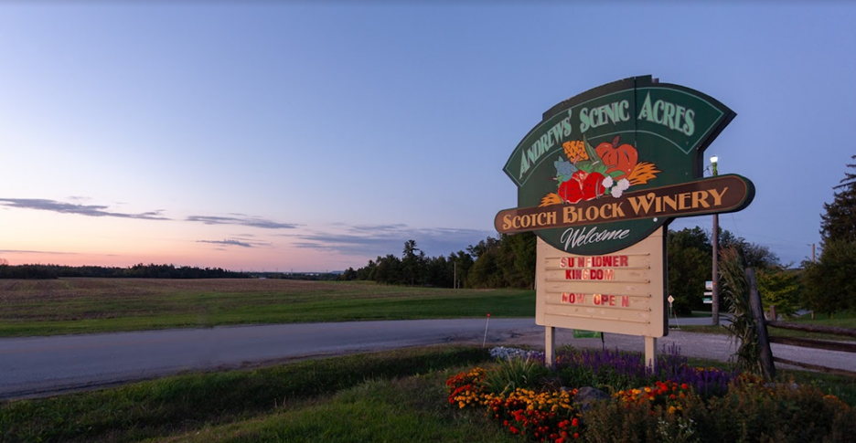 The large green sign in front of Andrews Farm Market and Winery