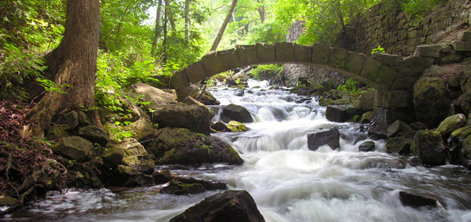 A stone bridge over a racing stream.