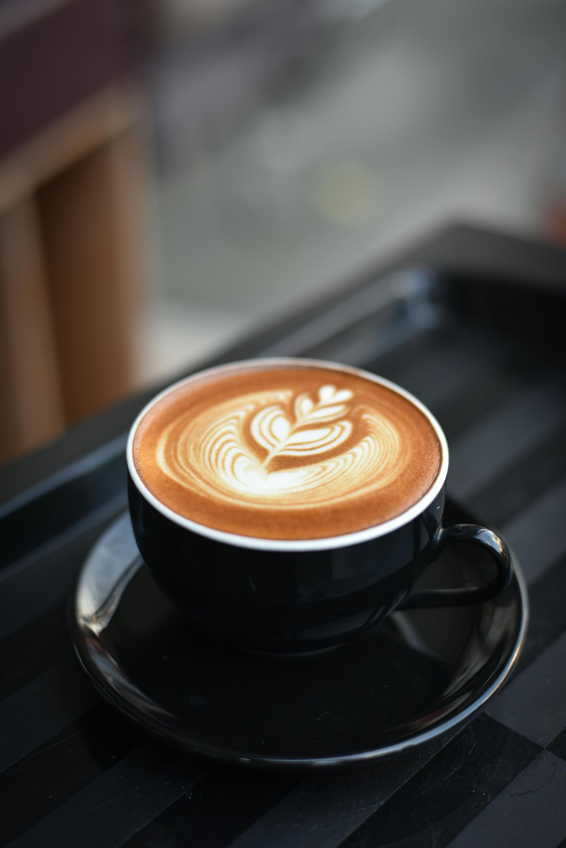 A close up image of a coffee with heart shaped coffee art.