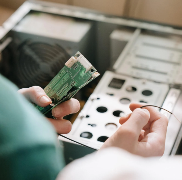 A person is holding a motherboard in their hands