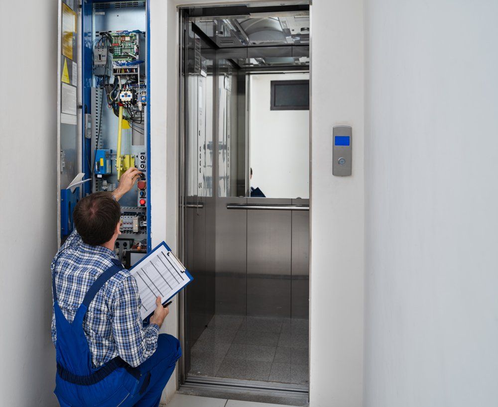 Professional Worker Checking on Elevator Electronic System
