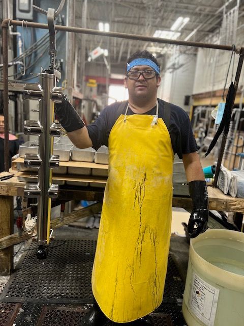 Person using a grinder to shape metal, creating sparks.