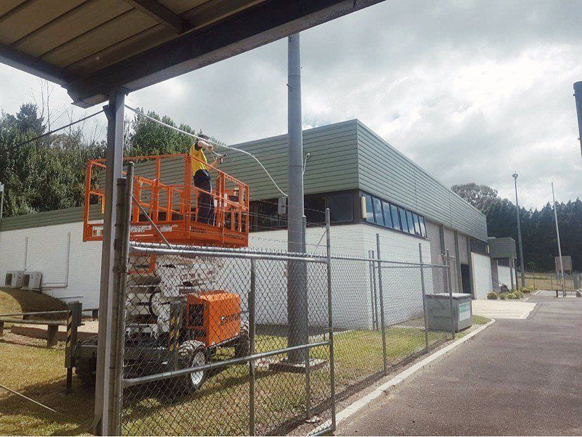 Electrician Working On The Lighting In The University — Electrical Contractors in Glen Innes, NSW