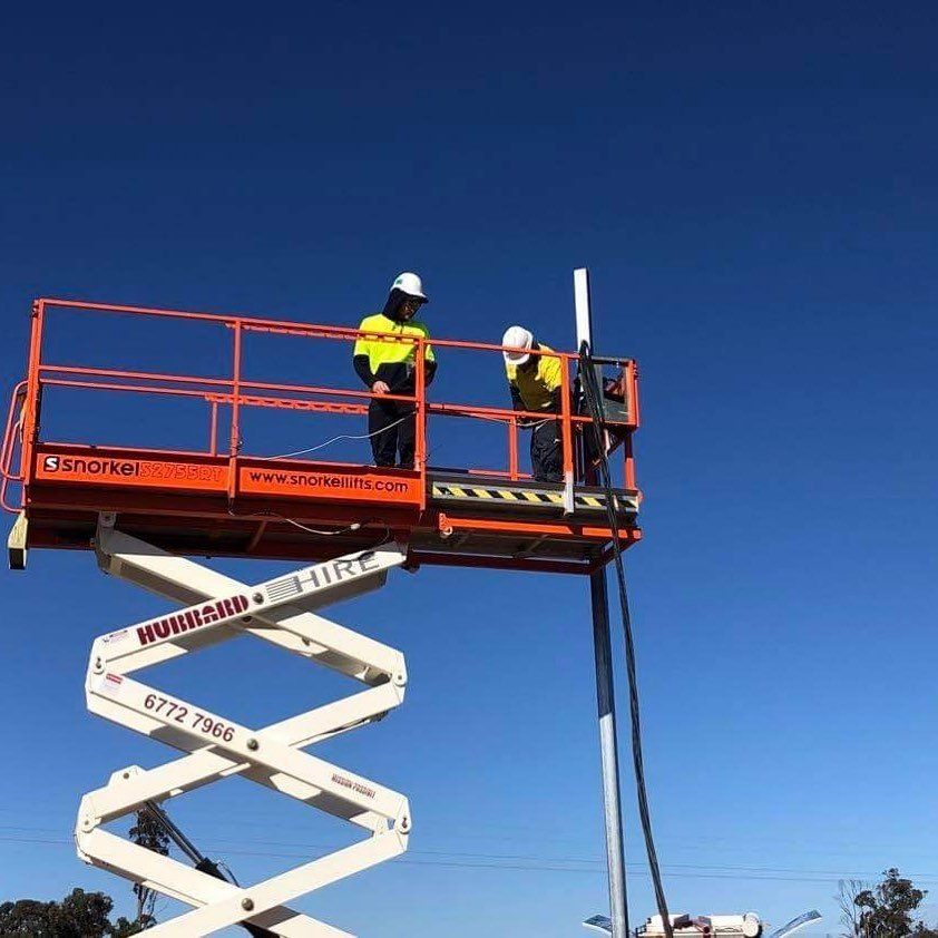 Two Electricians In A Snorkel Lift — Electrical Contractors in Armidale, NSW