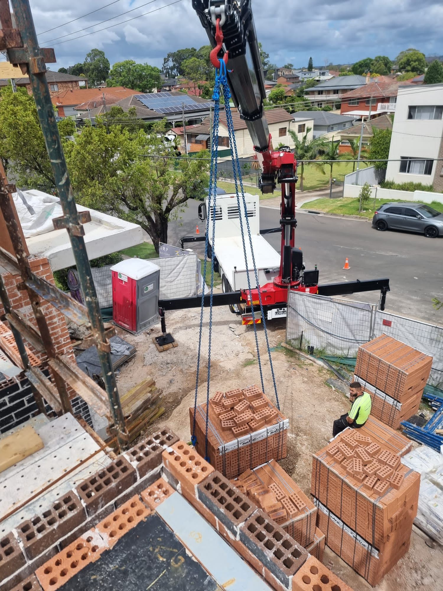 Man Sitting on Bricks — Sydney, NSW — Level8 Cranes