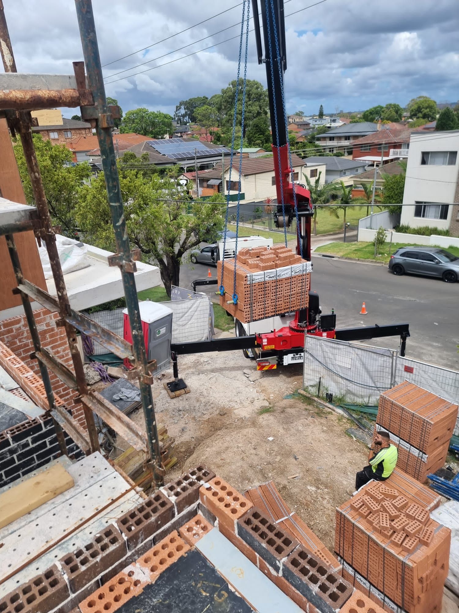 Lifting Bricks on House Construction — Sydney, NSW — Level8 Cranes