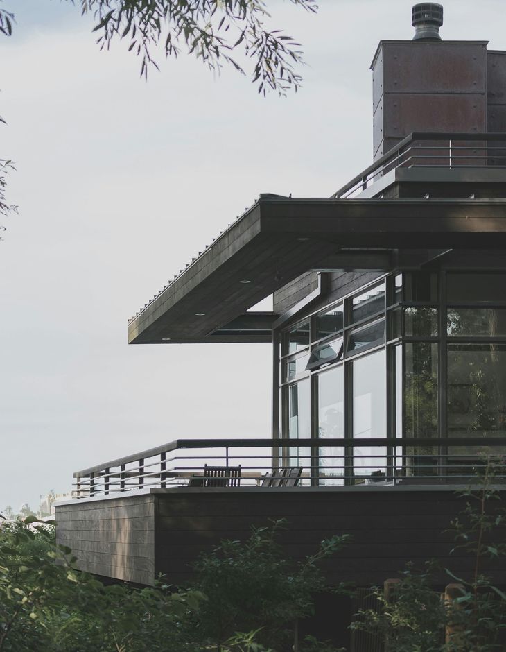 A house with a balcony and a chimney on top of it. Exterior window cleaning in Northville MI.