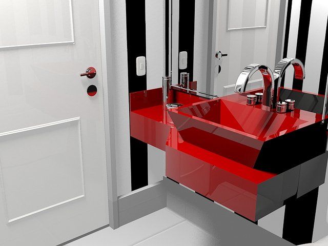 A bathroom with a red sink and a mirror. Devine Shine Window Cleaning Canton MI.
