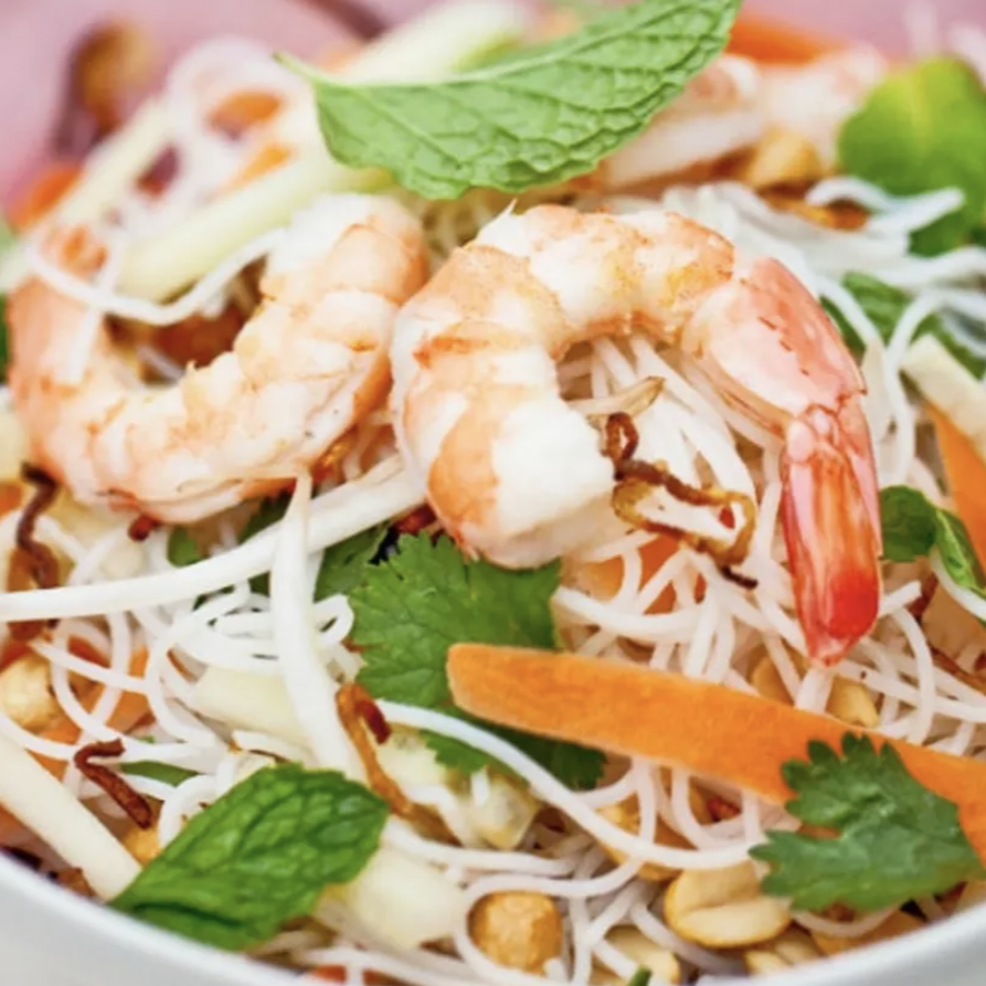 A close up of a salad with shrimp and noodles