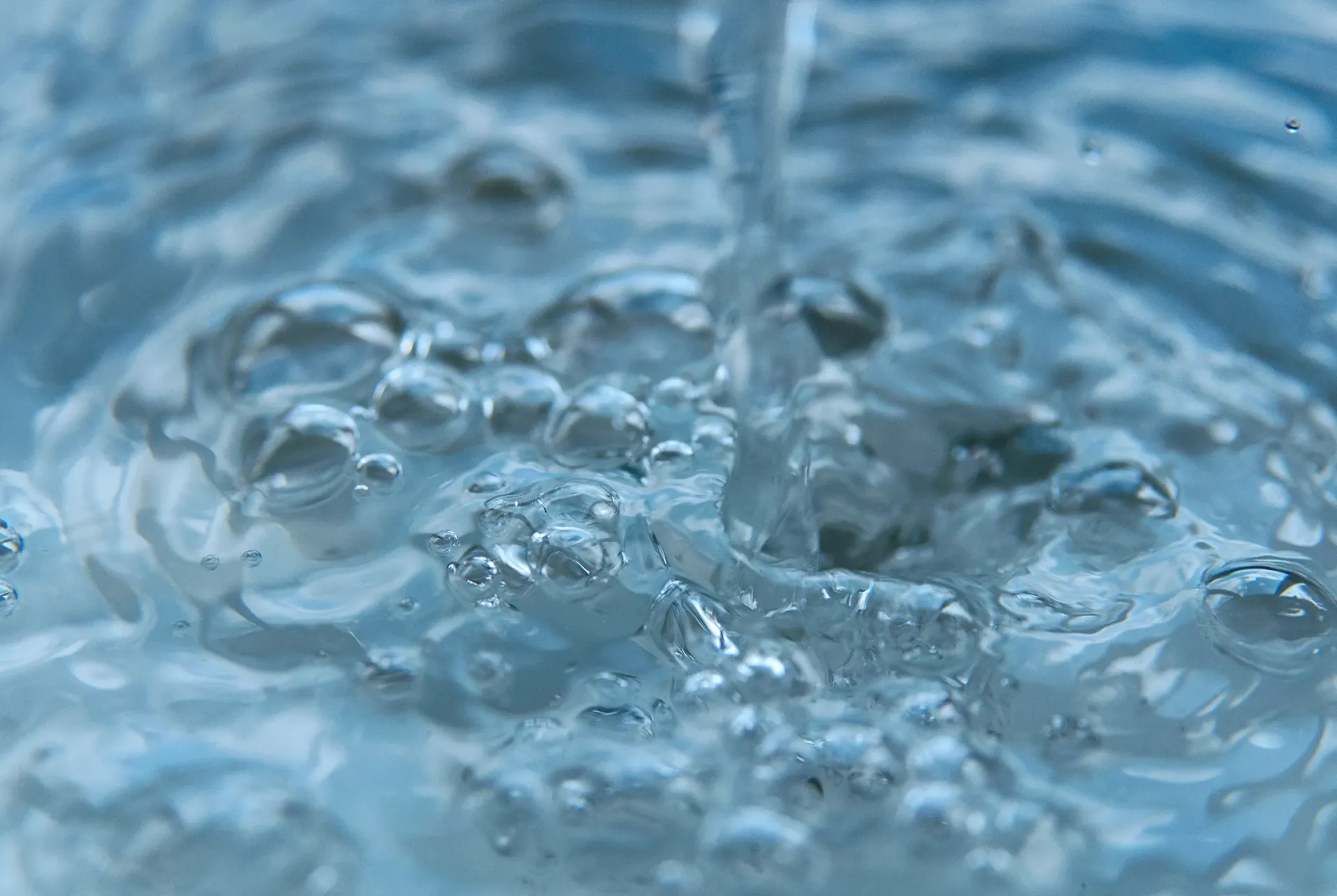 A close up of hot water being poured into a sink.