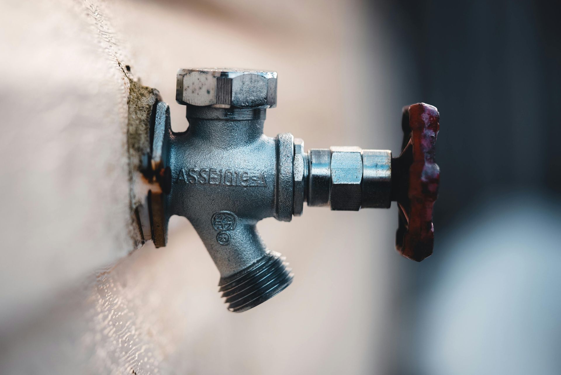 A close up of a water faucet on a wall.