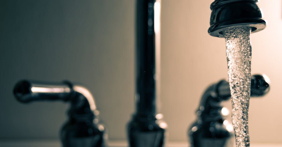 A close up of a faucet with water running out of it.