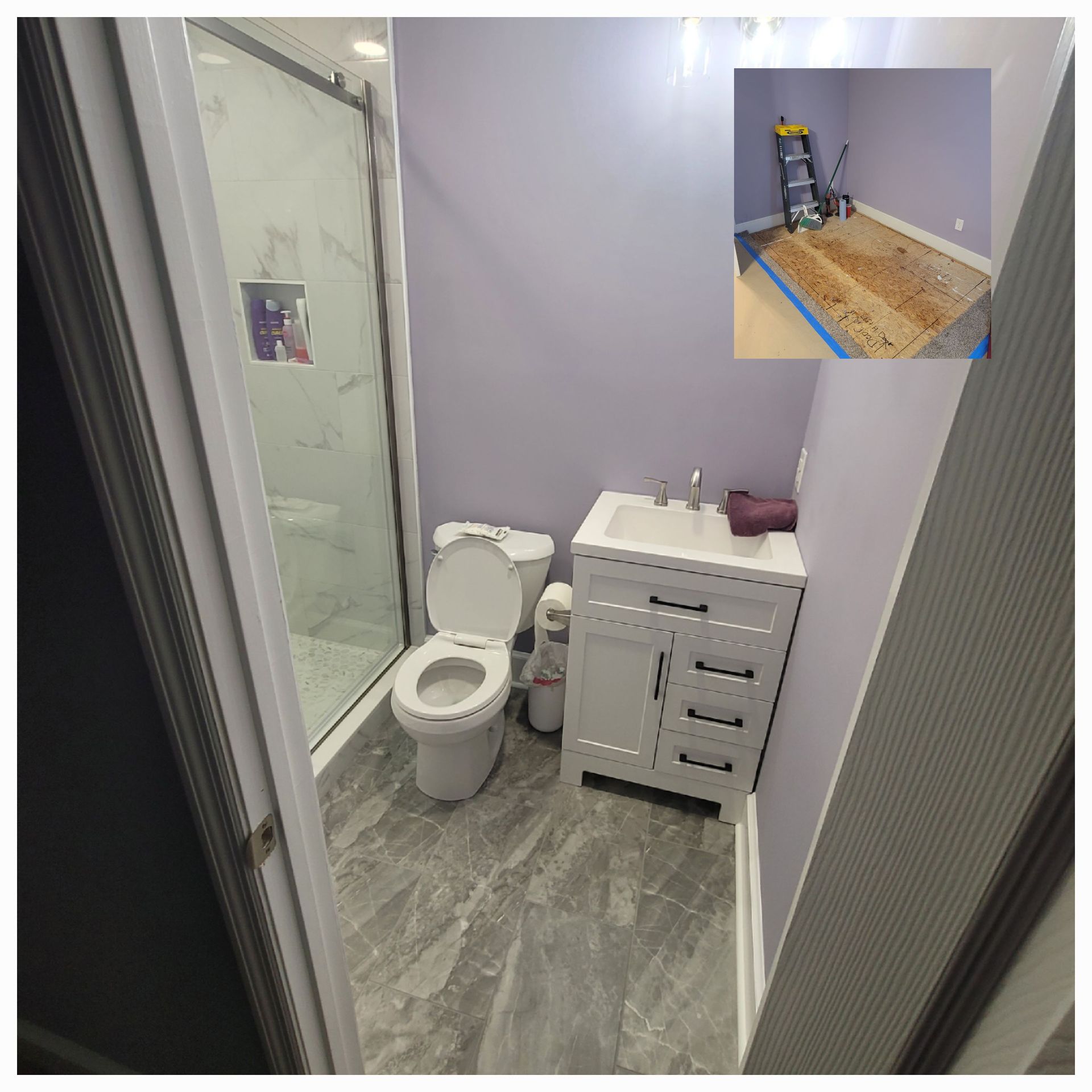 A bathroom with a toilet, white vanity, and walk-in shower, with a smaller inset photo showing the room under construction.