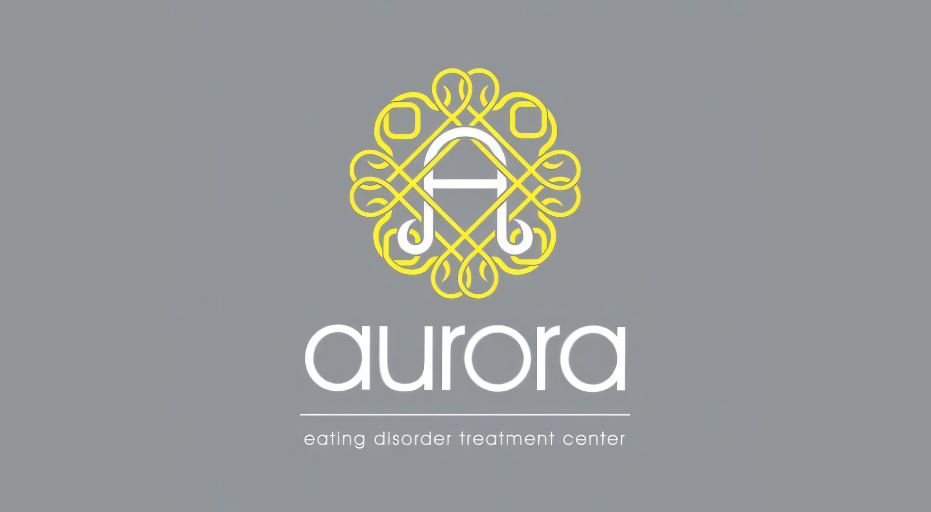 The logo for aurora is yellow and white on a gray background.