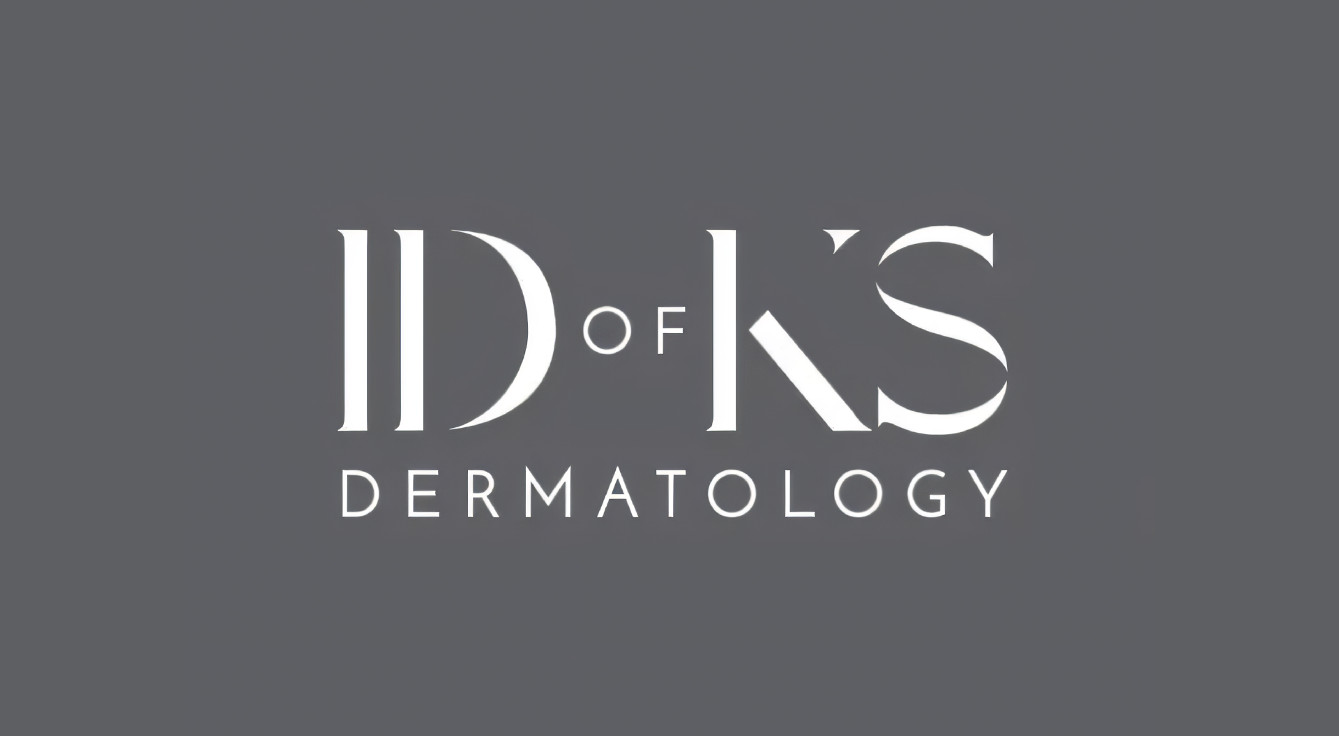 A logo for id of ks dermatology on a gray background