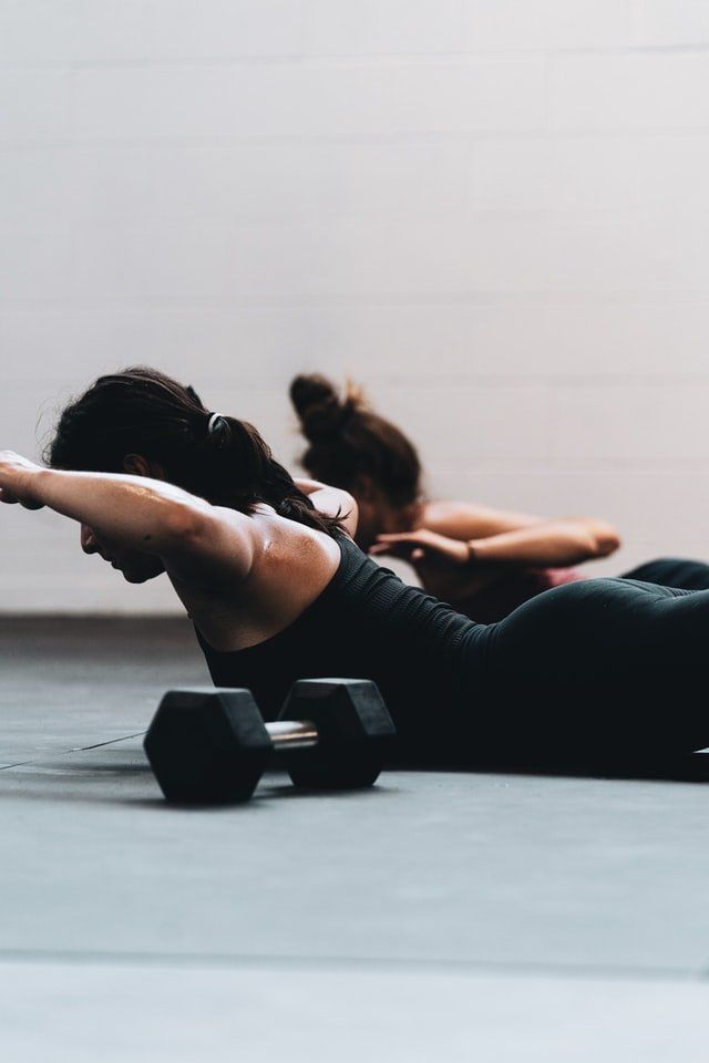 two woman's are doing exercise with dumbbells
