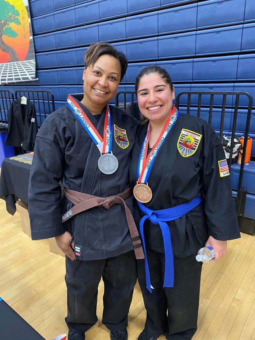 Two adult ladies wearing their medals