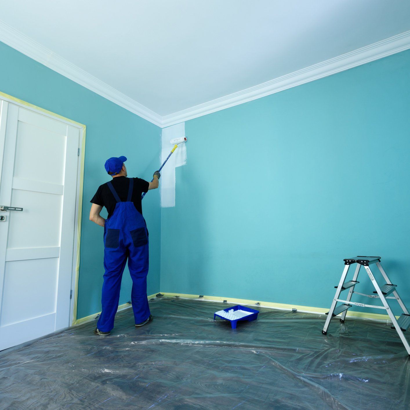 Man With Roller Painting Wall — Sioux Falls, SD — Norberg Paints