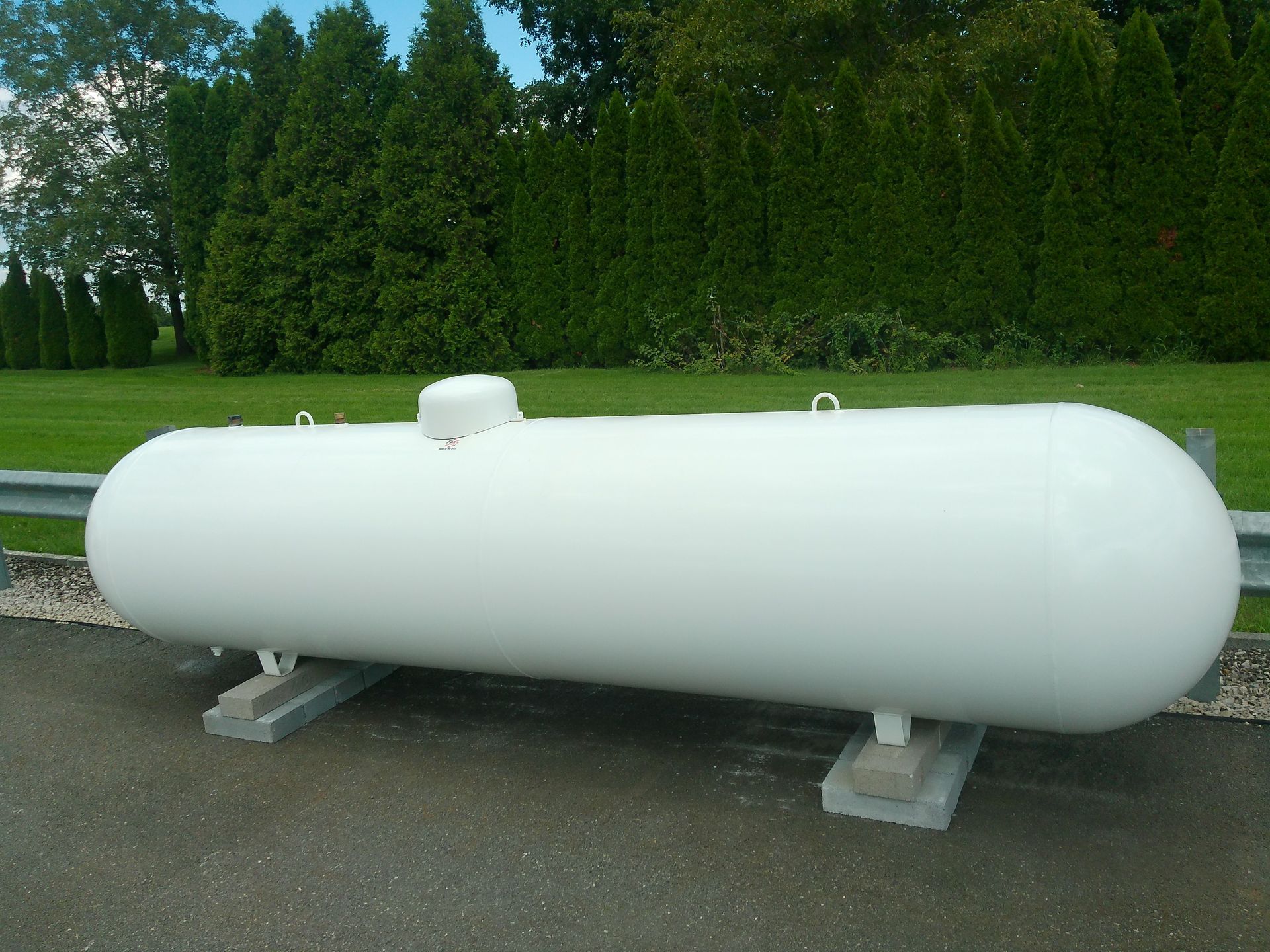 A Large White Cylinder Is Sitting on The Side of The Road