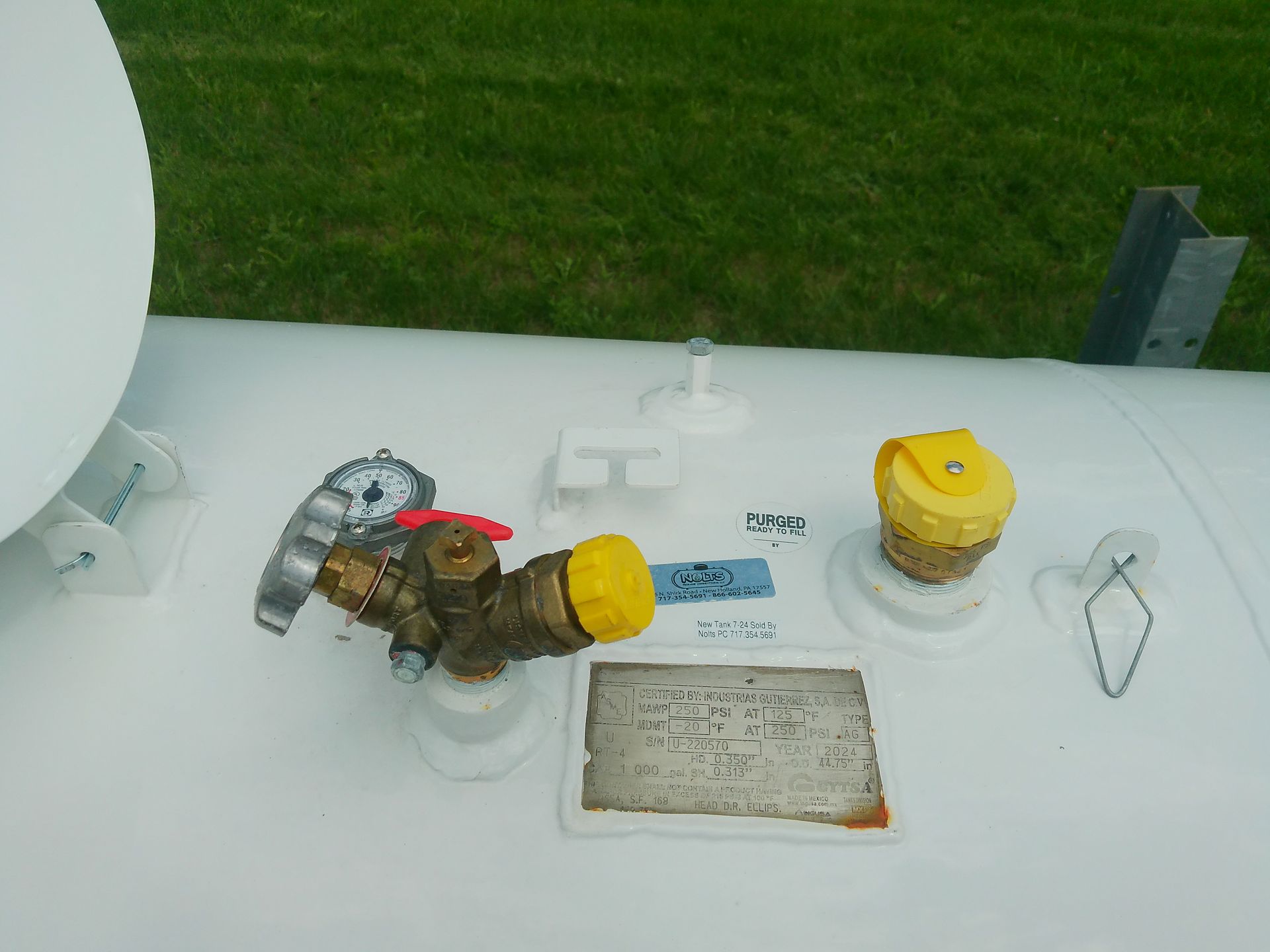 A White Tank with A Yellow Cap on It