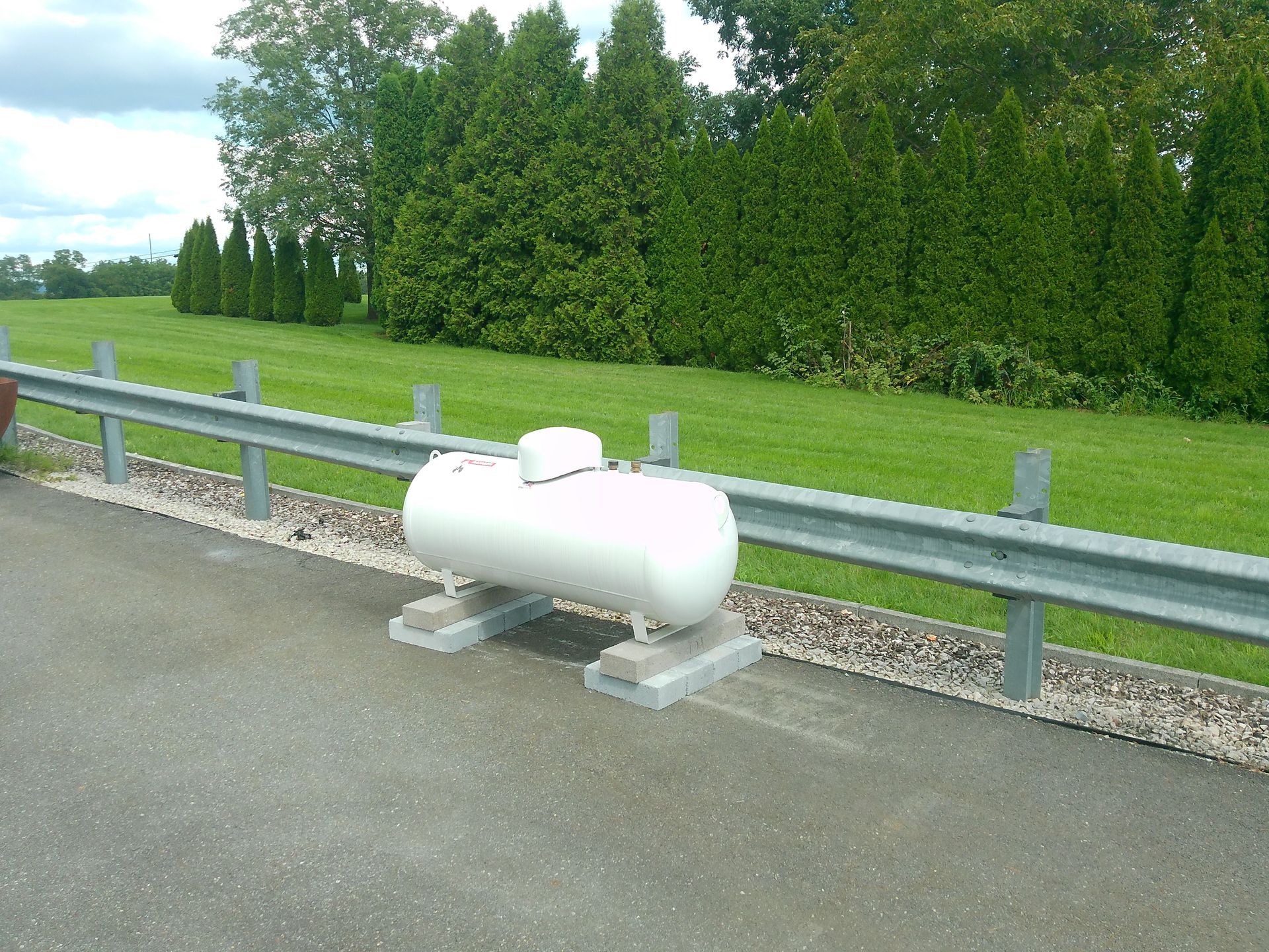 A Propane Tank Is Displaying on The Side of The Road