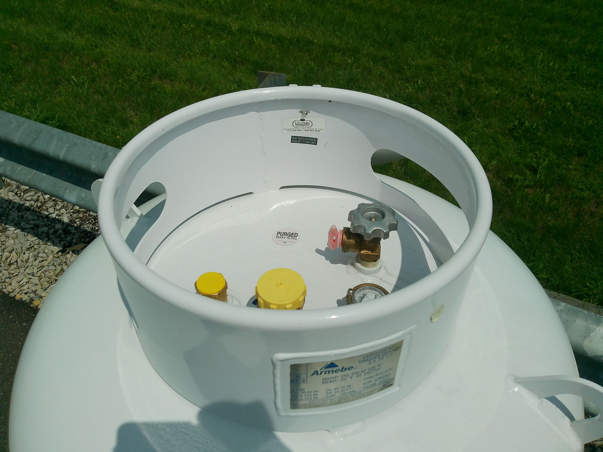 A White Propane Tank with A Yellow Cap on It