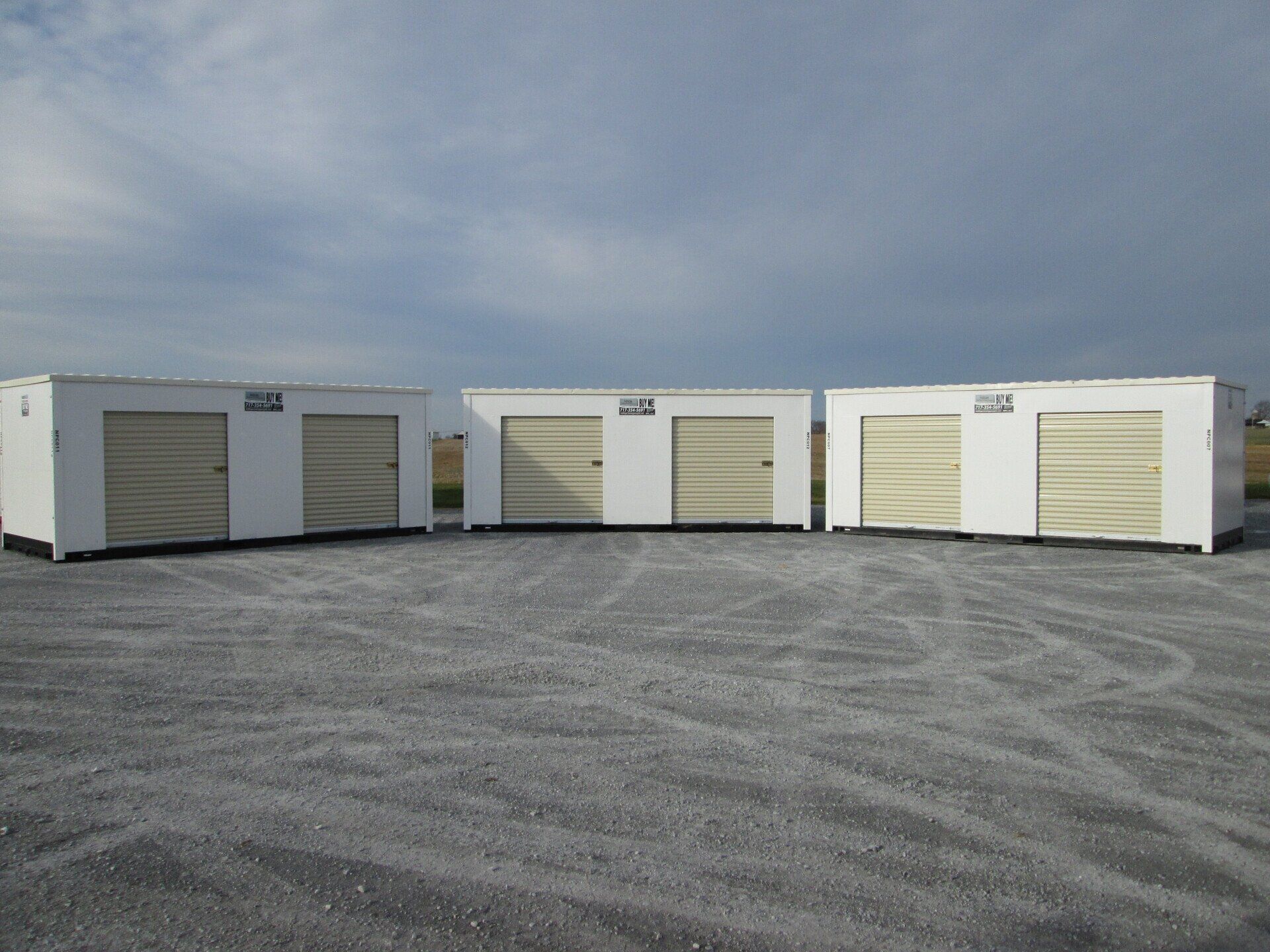 A row of white containers with tan doors in a gravel lot — New Holland, PA — Nolts Propane Connections