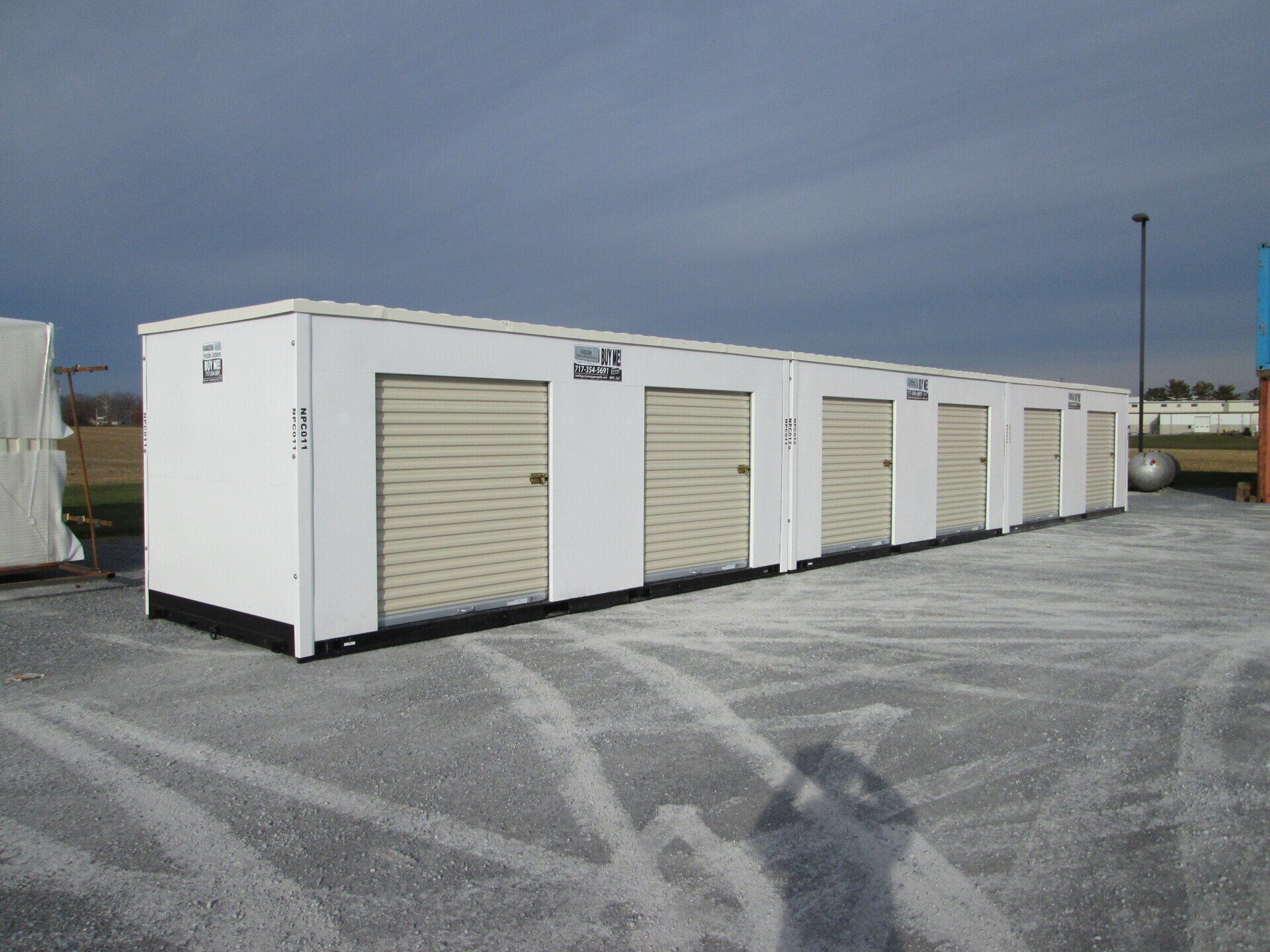 A row of white containers with tan doors in a parking lot — New Holland, PA — Nolts Propane Connections