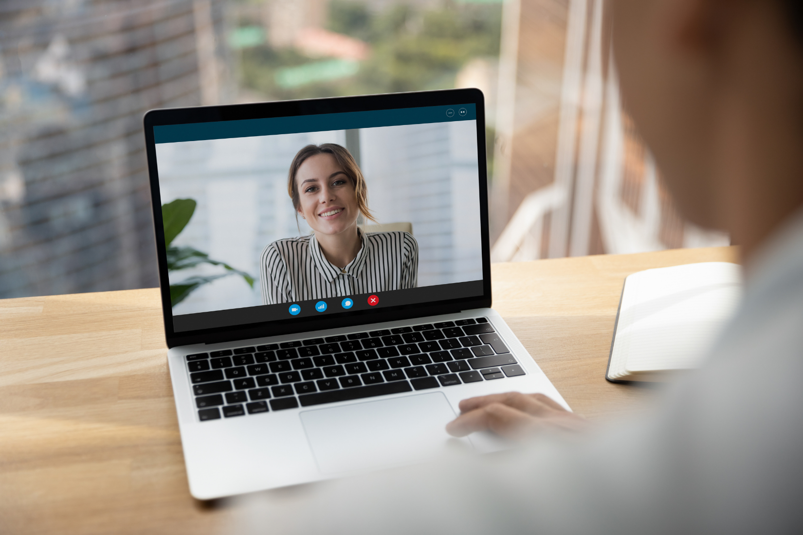 A woman is having a video call on a laptop computer.